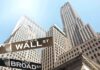 Street signs for Wall Street and Broad Street with skyscrapers in the background