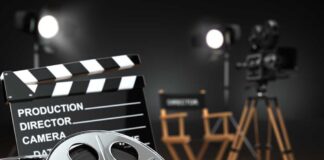 Film production equipment including a clapperboard, film reel, and directors chair