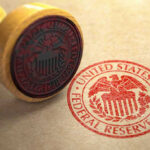 Rate Cut Shocker: Inflation Backlash Feared Federal Reserve stamp and wooden stamp on paper