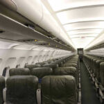 Empty airplane cabin with rows of seats