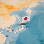 Massive Defense Shift—Japan Defies Limits Map of Japan with flag pin placed nearby