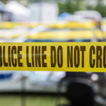 Yellow police line tape with Do Not Cross