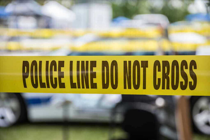 627591236 Yellow police line tape with Do Not Cross