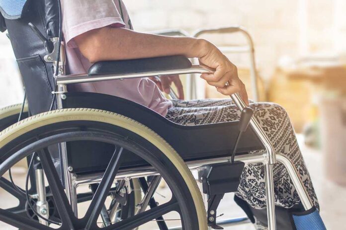 shutterstock_1174811467.jpg Close-up of a person sitting in a wheelchair with patterned pants