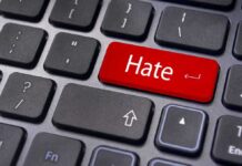 Close up of a keyboard with a red key labeled Hate