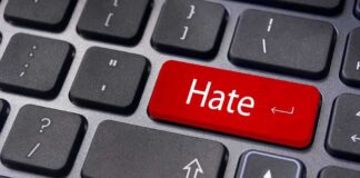Close up of a keyboard with a red key labeled Hate