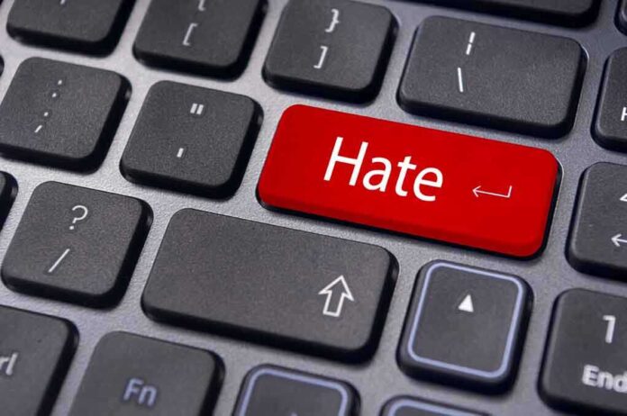 Close up of a keyboard with a red key labeled Hate