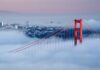 Golden Gate Bridge emerging from fog with San Francisco in the background