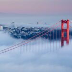 Golden Gate Bridge emerging from fog with San Francisco in the background