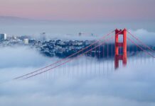 Golden Gate Bridge emerging from fog with San Francisco in the background
