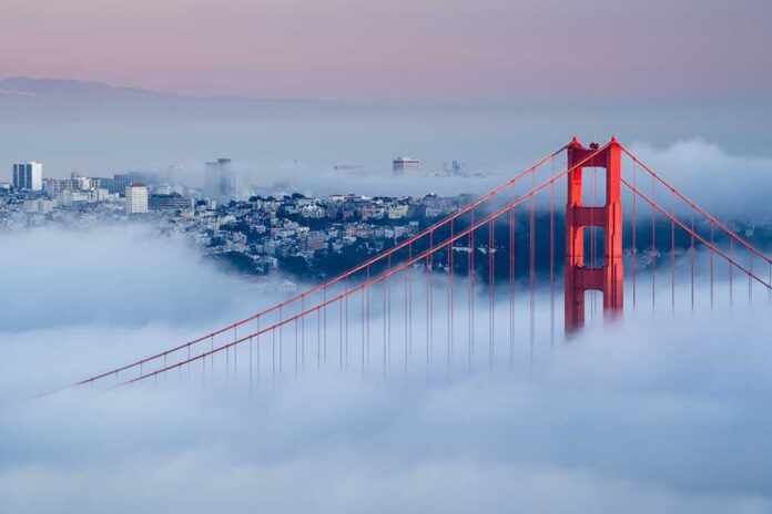 shutterstock_121582312.jpg Golden Gate Bridge emerging from fog with San Francisco in the background
