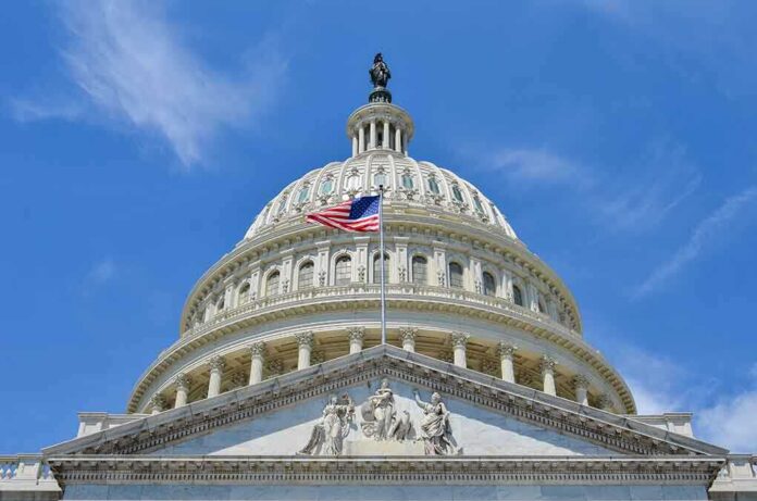 The U.S. Capitol building with an American flag flying in front against a blue sky