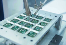Body-Embedded Chip Fiasco – No Way Out! Robotic arm assembling electronic circuit boards in production.