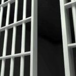 UNBELIEVABLE Twist: Prisoner Becomes Court Boss Close-up view of metal prison bars in a dark environment
