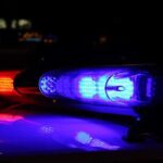 Officer’s Life Hangs After Motorcade Disaster Close-up of police lights flashing in blue and red at night