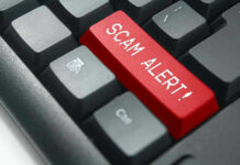 Christmas Parcel Scam EXPLODES Overnight Close-up of keyboard with red SCAM ALERT key.