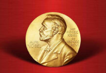 Nobel Laureate’s Violent Arrest Shocks World Gold Nobel Prize medal on red background.