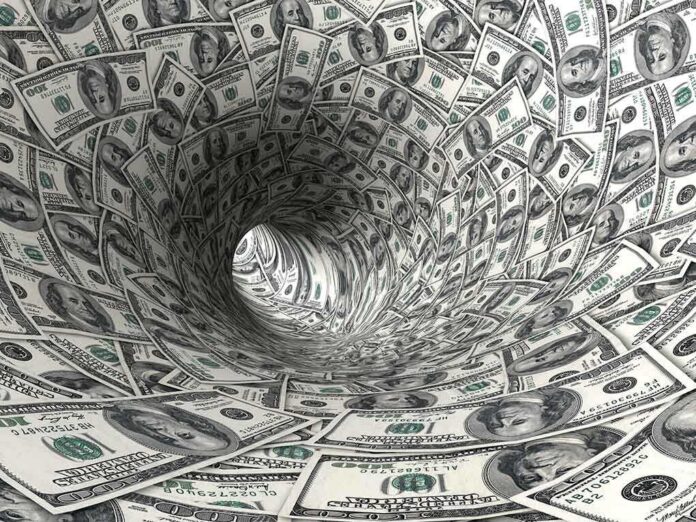 shutterstock_31516636.jpg A swirling tunnel made of dollar bills creating a vortex effect