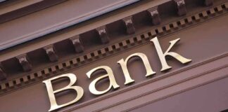 Close-up of a bank sign with gold lettering