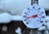 Outdoor thermometer displaying a very low temperature in a snowy setting