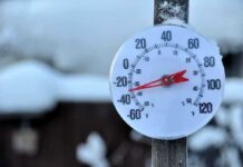 Outdoor thermometer displaying a very low temperature in a snowy setting