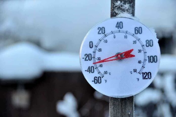 Outdoor thermometer displaying a very low temperature in a snowy setting