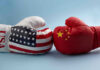 Stealth US Wall Rises Near China USA and China boxing gloves facing each other.