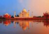 The Taj Mahal reflecting in water during sunset