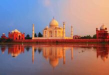 The Taj Mahal reflecting in water during sunset