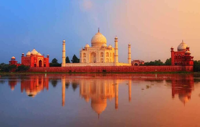 The Taj Mahal reflecting in water during sunset