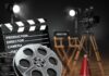 Film production equipment including a clapperboard, film reel, and directors chair