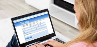 Person filling survey on a laptop.