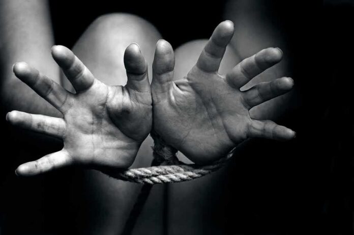 shutterstock_146428184 (3).jpg Two hands reaching out, bound by rope in a black and white image