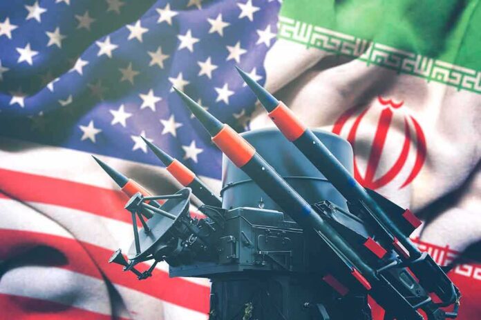 shutterstock_1628170834 (1).jpg Missile launcher in front of US and Iran flags