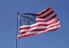 Waving American flag against a clear blue sky