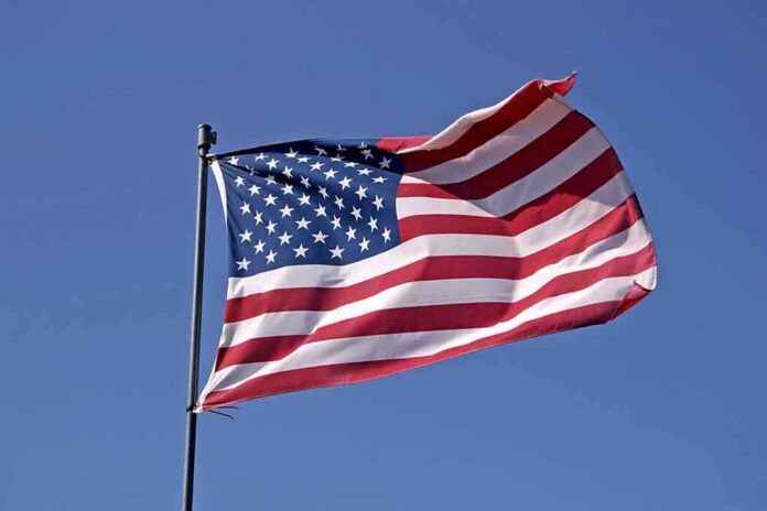 Waving American flag against a clear blue sky