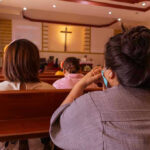 Pope ABANDONS 2,000 Years of CHURCH TEACHINGS People sitting in church pews during service.
