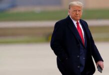 Donald Trump walking outdoors in formal attire