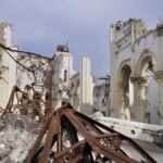 Families DESTROY Own Homes With Bare Hands Interior view of a destroyed building with collapsed arches and debris