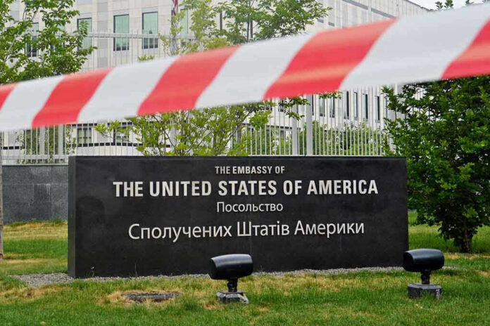 656626315 U.S. Embassy sign behind red-and-white caution tape.