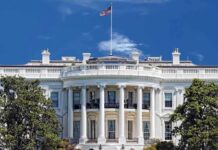 Trump–Brazil MEETING — What’s HIDDEN Behind Closed Doors? The White House with the American flag flying against a blue sky