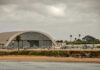 Cartel Boat Strikes Set to Expand as Critics Cry Foul Aircraft hangar with helicopters near the beach.