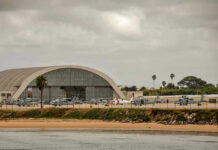 Cartel Boat Strikes Set to Expand as Critics Cry Foul Aircraft hangar with helicopters near the beach.