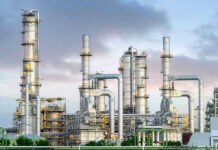 U.S. Iran Threats Over Oil Spark Global Shock Industrial plant with metal towers and pipes.