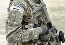 Israel Vows Indefinite “Security Zone” in Lebanon Soldier in camouflage gear with Israeli flag patch.