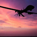 Trump Says Peace, Iran Says No Deal Silhouette of a drone against a colorful sunset.