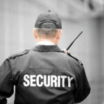 Security guard holding a walkie-talkie.
