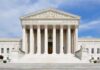 Supreme Showdown Over Birthright Begins Front view of the Supreme Court building with large columns and steps under a blue sky