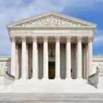 Supreme Showdown Over Birthright Begins Front view of the Supreme Court building with large columns and steps under a blue sky