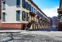 Row houses along a cobblestone street in an urban setting